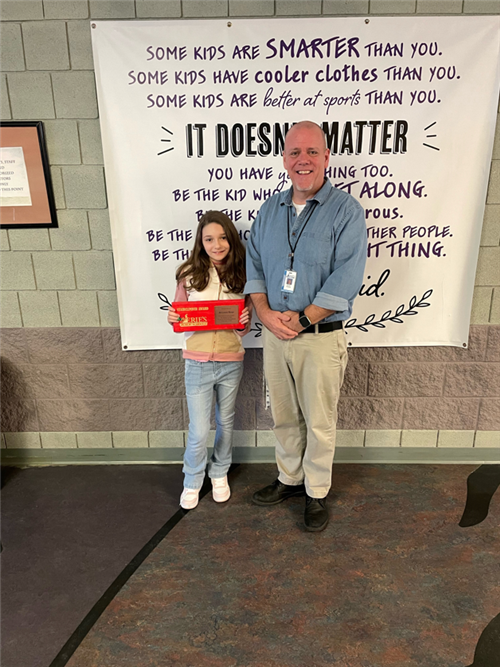 Arianna Rosa, Harding's February Stairclimber, poses with her plaque and Assistant Principal Jeff Yonkers.
